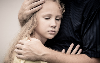 father hugging daughter